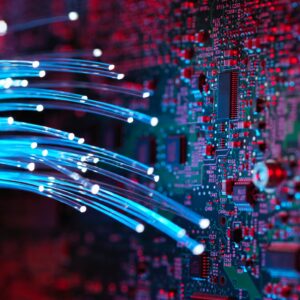 Fibre optics flowing through circuit boards from a laptop computer, close-up